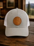 Men's Light Gray Front With White Mesh Trucker Hat Featuring Brown Leather Patch. Fixed Price $19.00.